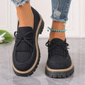 Black plus size women's loafer with tassel decoration and a bowknot on a low chunky heel.