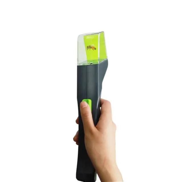 Green plastic handheld insect catcher for garden and grass pest control