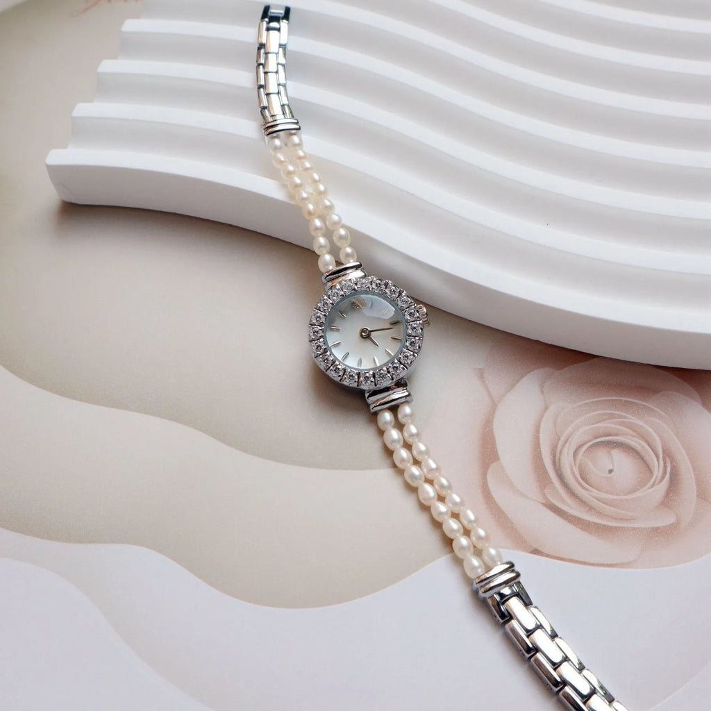 Women's light gold bracelet watch with freshwater pearls, round dial and stainless steel strap