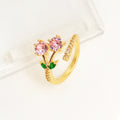 Gold and zircon geometric leaf design on a women's copper open ring.