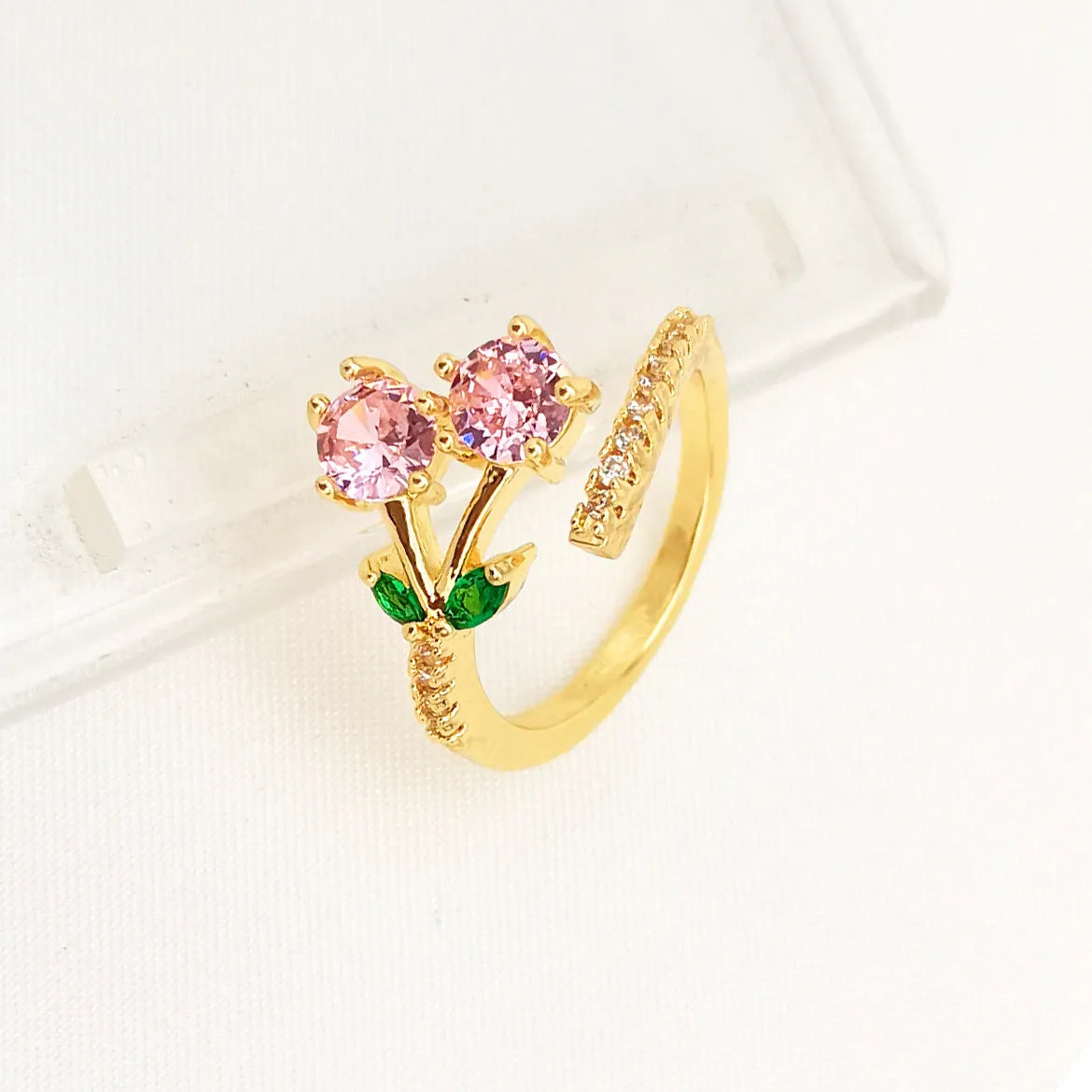 Gold and zircon geometric leaf design on a women's copper open ring.