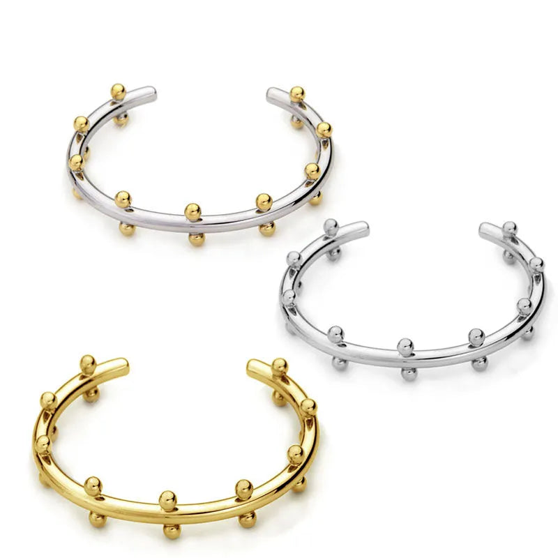 C-shaped stainless steel bean bead bracelet with textured finish and rivet detailing