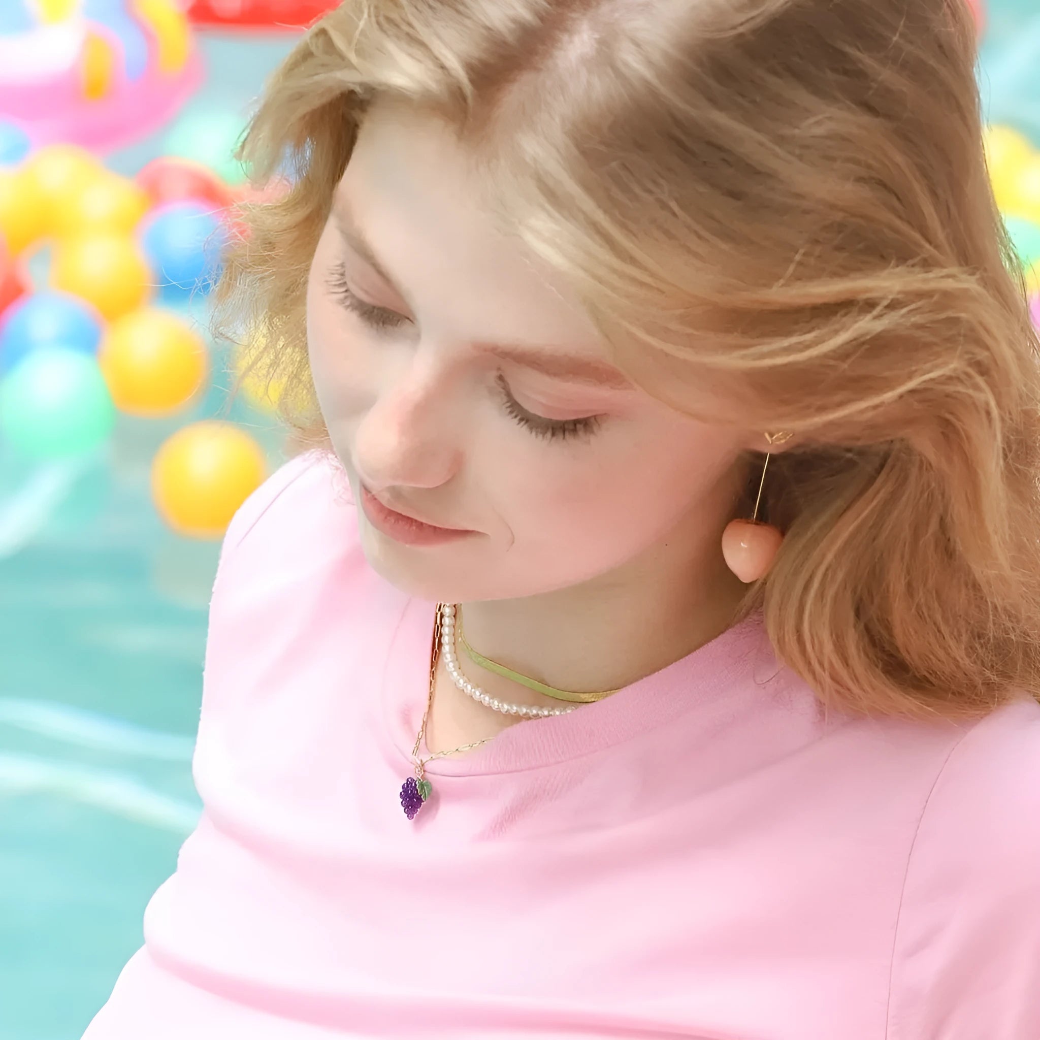 Gold plated copper earrings featuring fruit and vegetable shapes in multiple colours on display