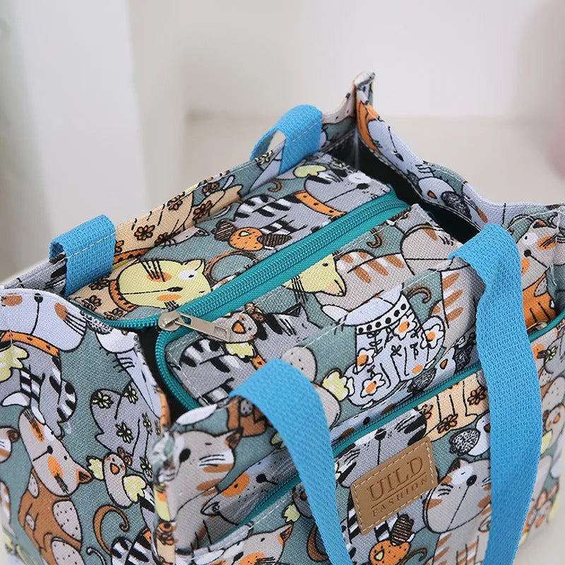 Women's printed canvas handbag with aluminium hardware in a selection of floral and animal designs.