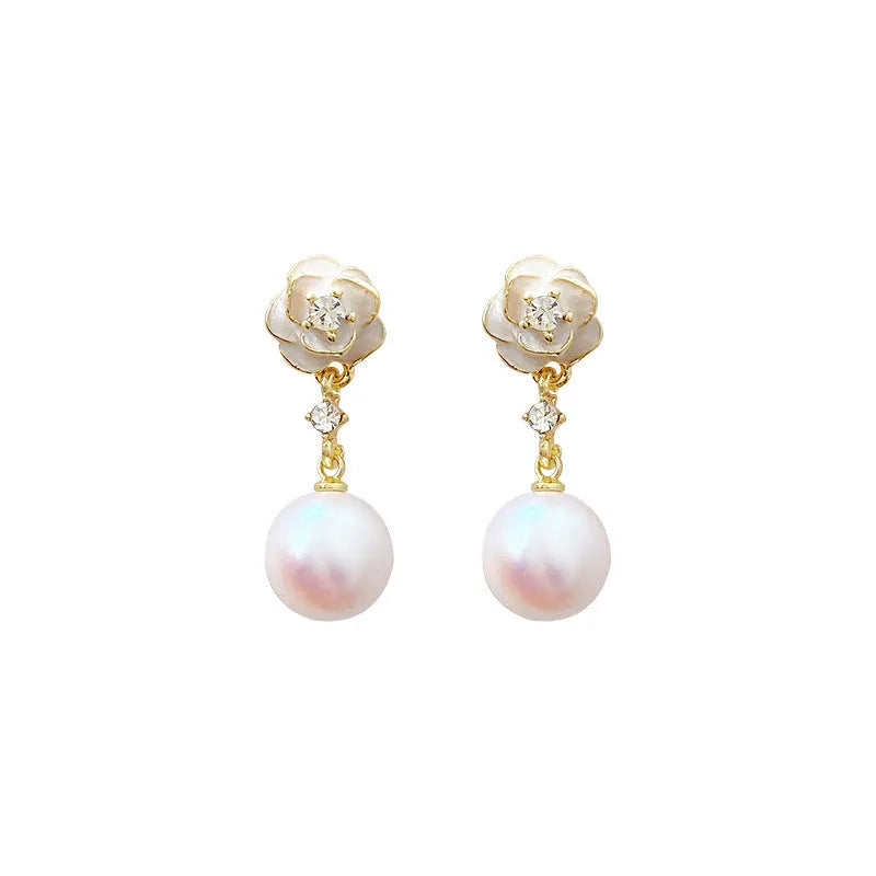 Close-up of women's alloy camellia flower stud earrings with a pearl detail on a white background.