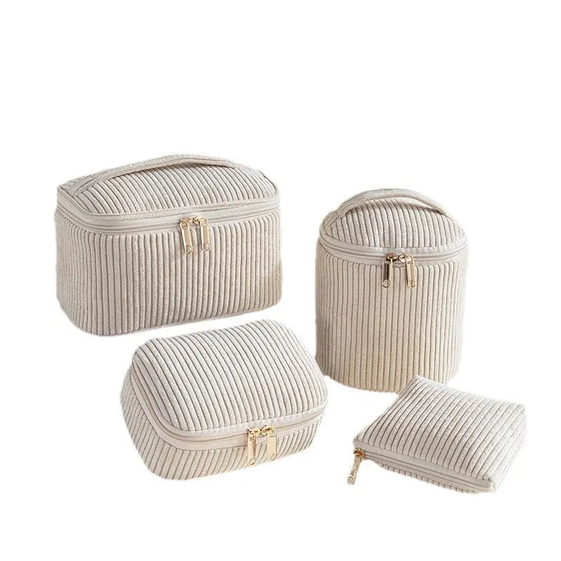 Four cube-shaped makeup bags in matching colour sets for travel cosmetic organisation