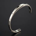 Open-ended stainless steel women's bracelet with inlaid zircon stones and love heart design in electroplated rose gold finish