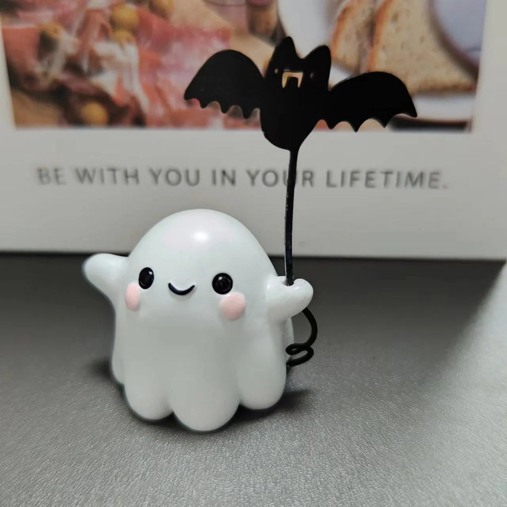Miniature resin statue of a ghost walking a dog, Halloween decoration measuring 4x5x4cm.
