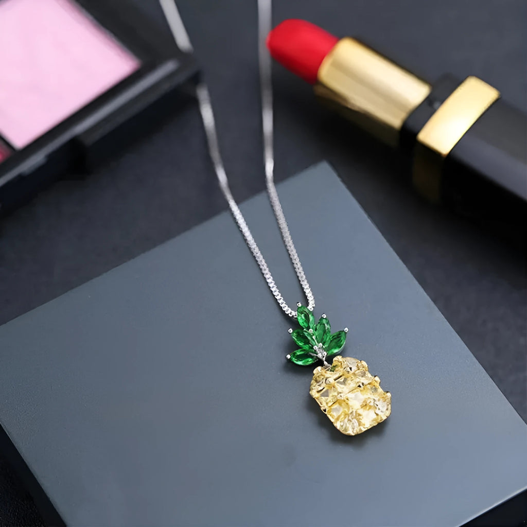Silver women's necklace with a geometric pineapple and diamond design pendant on a chain.