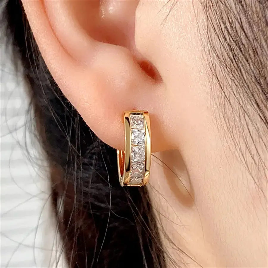A pair of geometric quadrilateral earrings for women in a gold or silver metal finish.