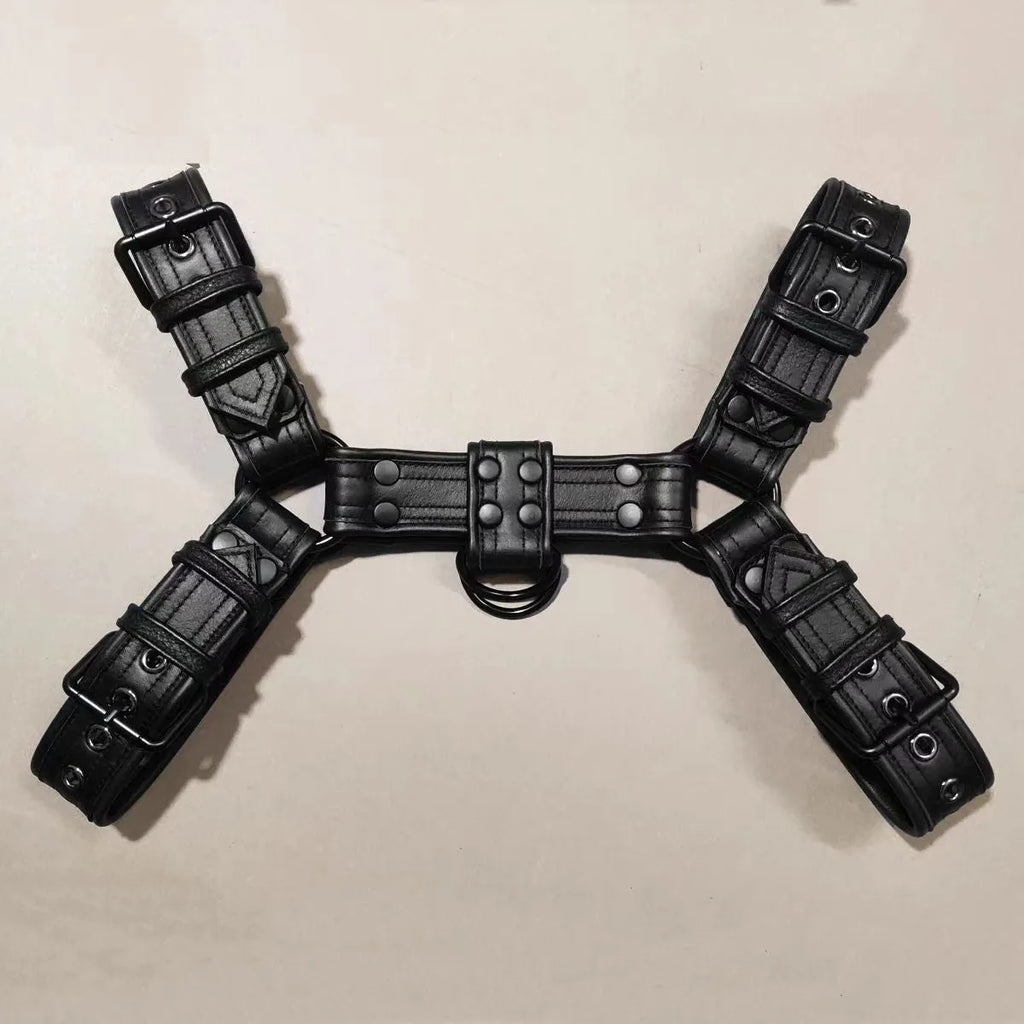 Black leather chest harness strap with metal buckles for men's bondage costume.