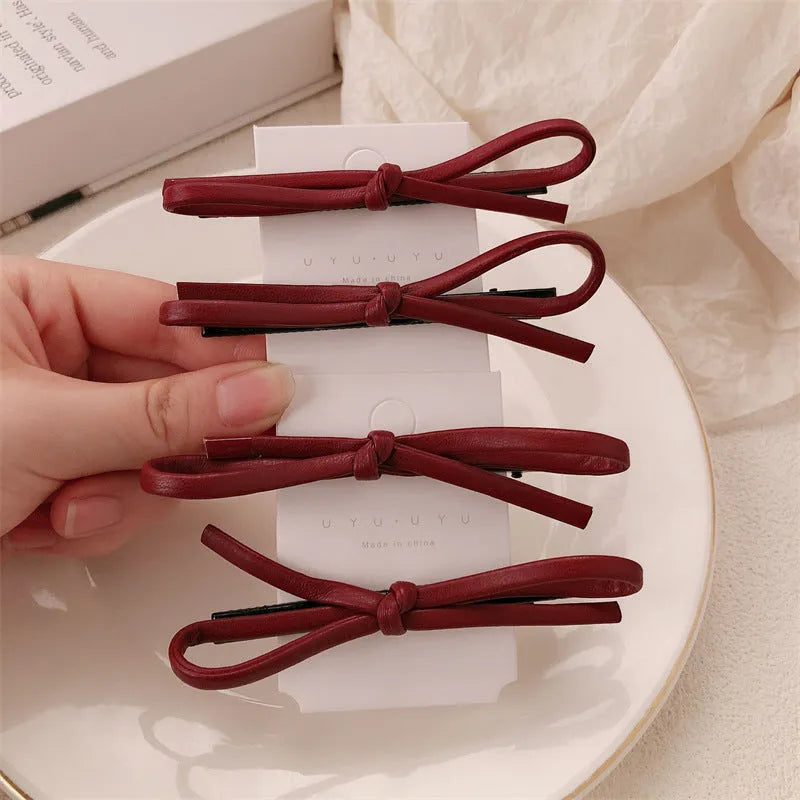 Wine red leather bow barrettes hair clips with structured design
