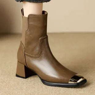 Brown women's cowhide leather Martin boots with a high heel and side zipper on a white background.