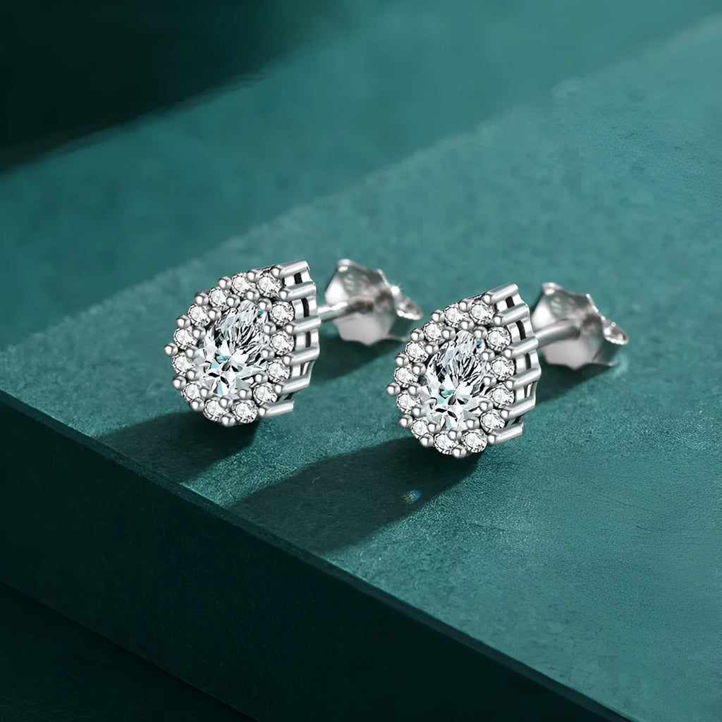 Silver drop-shaped ear studs with diamond-cut surface detail on 925 sterling silver