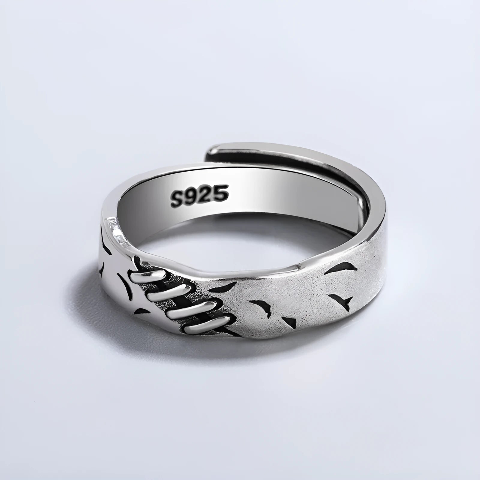 Black copper geometric adjustable ring with round and oval shapes on a white background