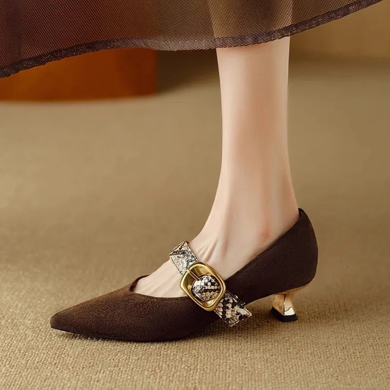 Women's black French pointed stiletto heels with an ankle buckle on a rubber sole.