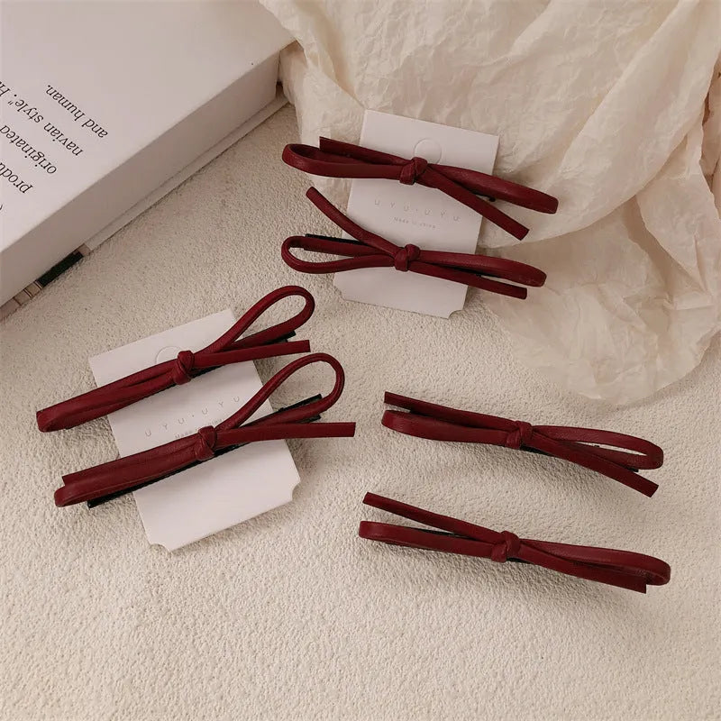 Wine red leather bow barrettes hair clips with structured design