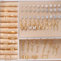 108 gold and yellow geometric round pearl earrings spread out, showing electroplated alloy construction.