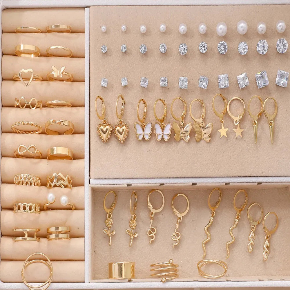 108 gold and yellow geometric round pearl earrings spread out, showing electroplated alloy construction.