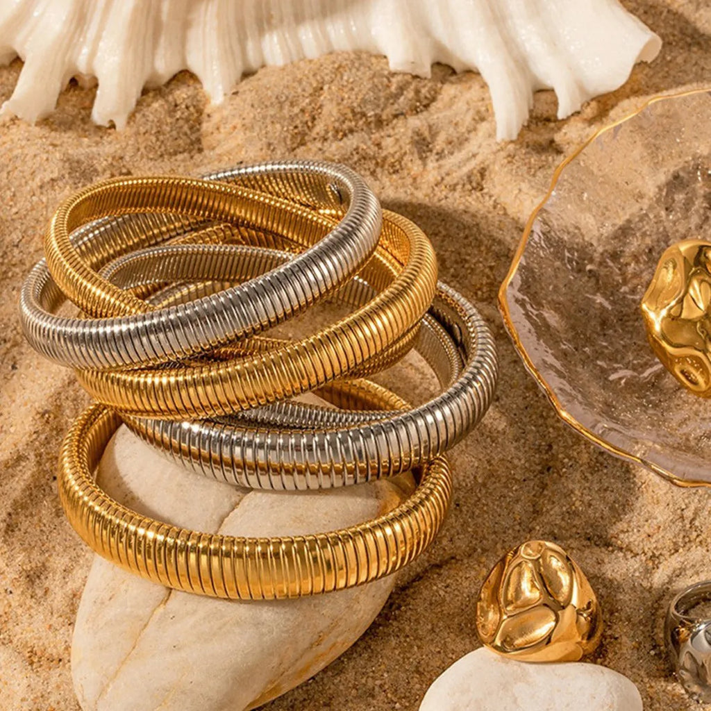 Women's titanium steel bracelet with vertical stripes in gold finish, elastic ring design