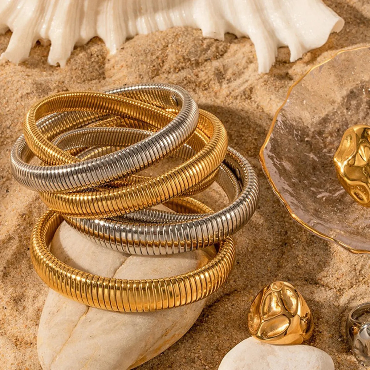 Women's titanium steel bracelet with vertical stripes in gold finish, elastic ring design