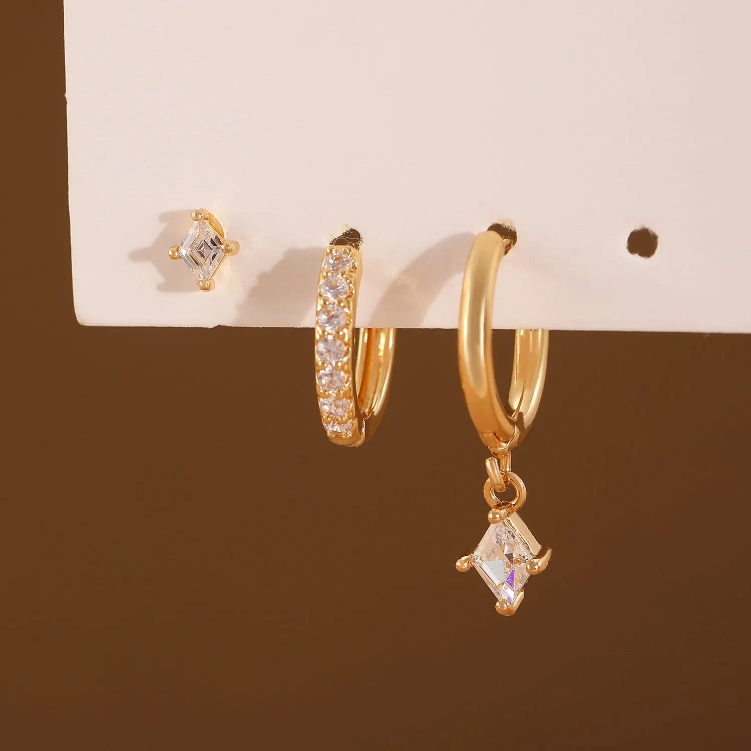 Copper jewellery three-piece set showing ear ring, ear clip, and ear studs with geometric zircon designs