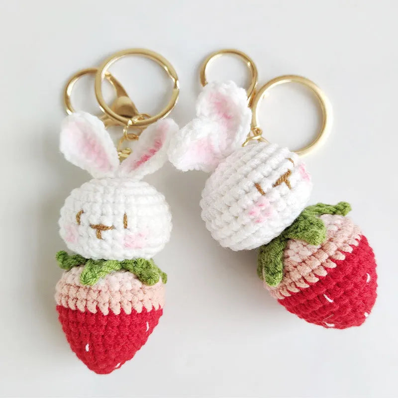 White hand-woven wire pendant with rabbit and strawberry design on a key fitting.