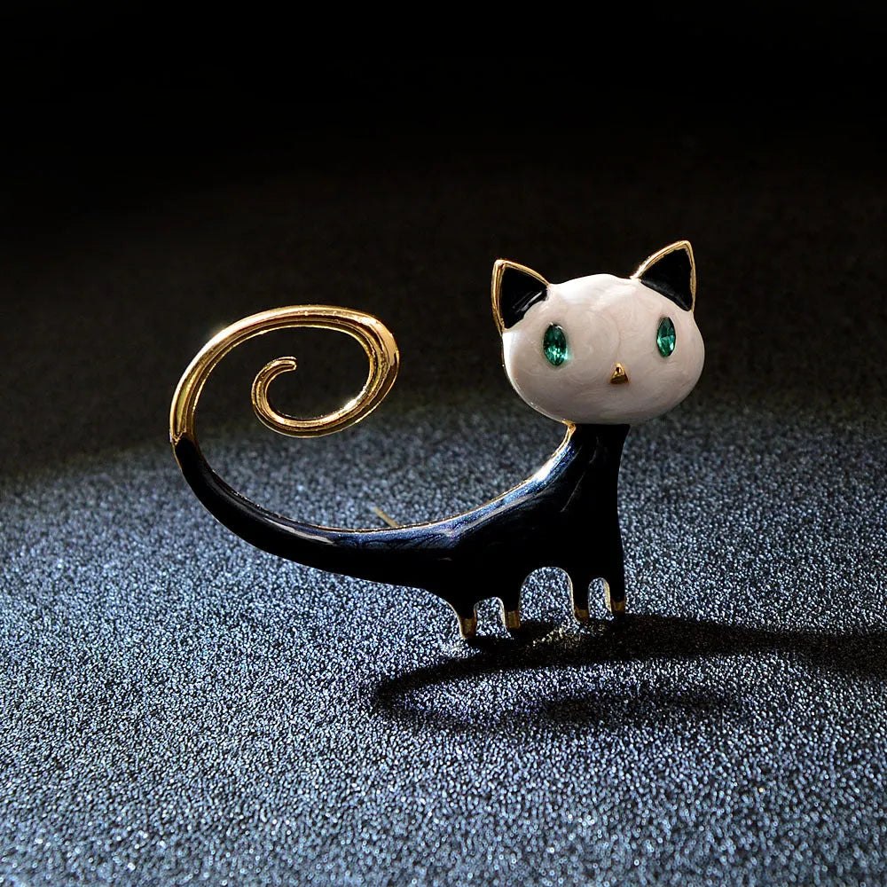 White or orange painted cat brooch with tailing up design on alloy metal