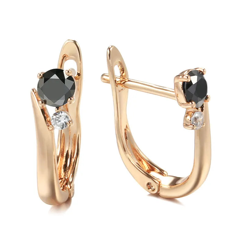 Gold coloured drop earrings with black agate stone centre and geometric design on copper settings