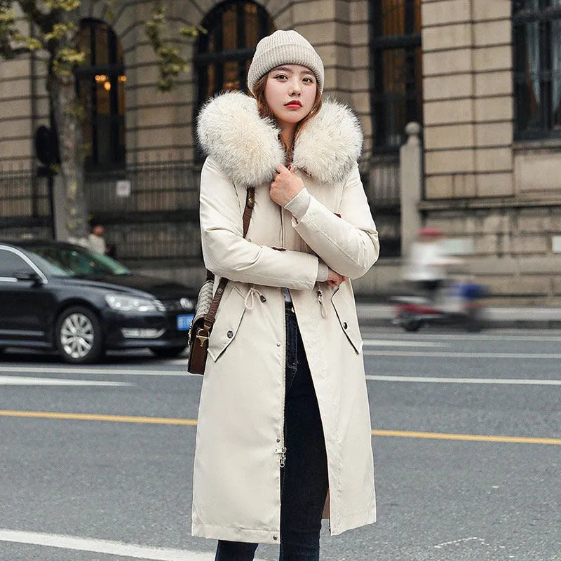 Women's long white padded trench coat with down cotton filler and fleece construction on a hanger.