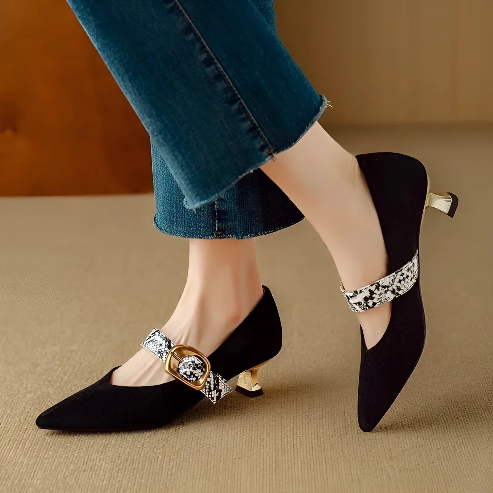 Women's black French pointed stiletto heels with an ankle buckle on a rubber sole.