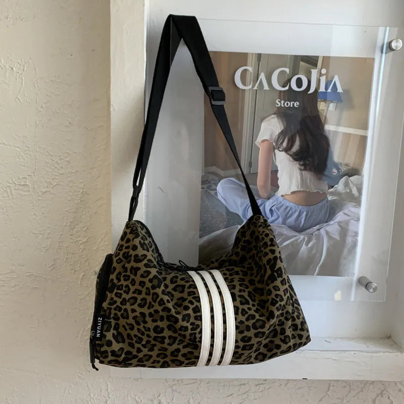 Large capacity leopard print sports style shoulder messenger bag with cloth construction and stitching details