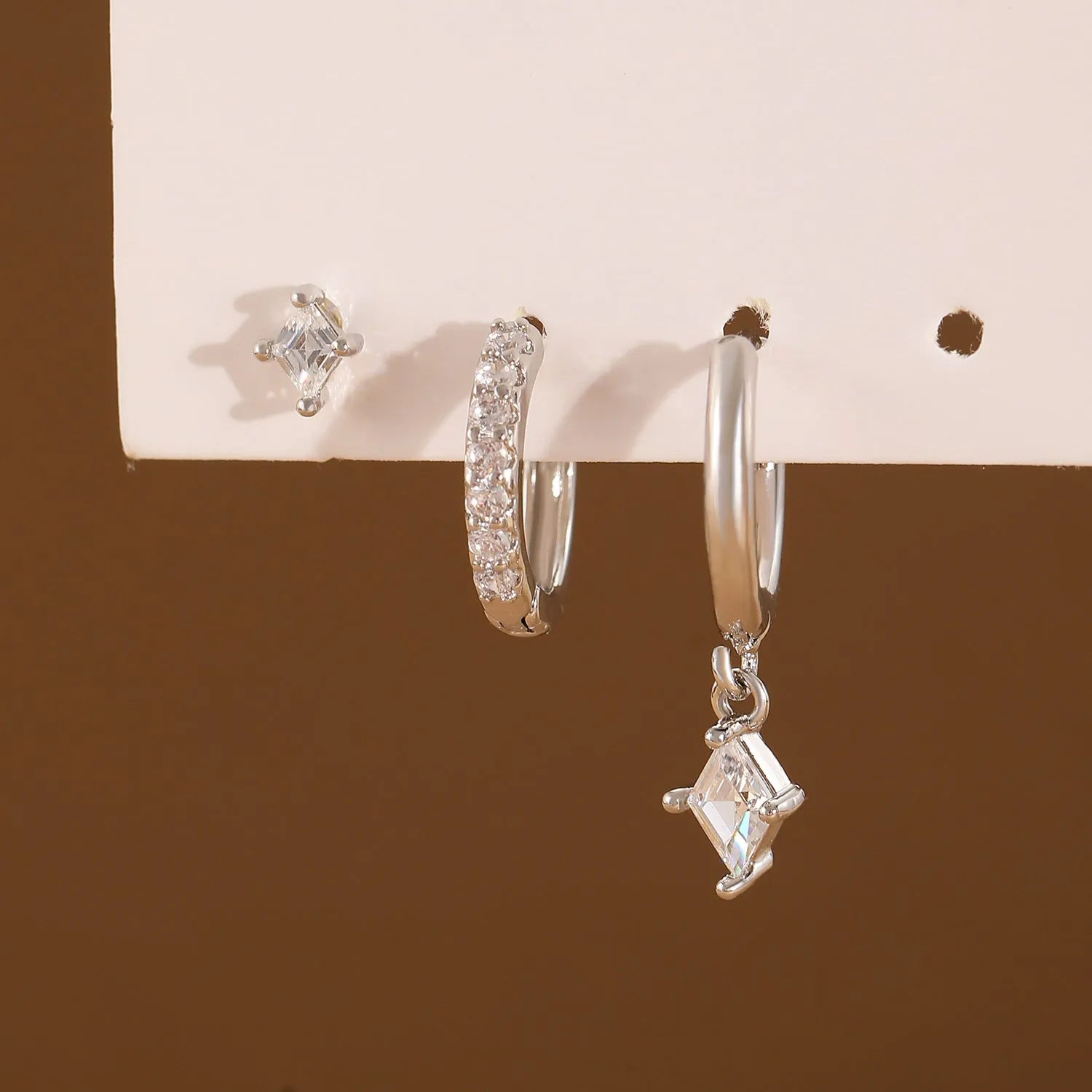 Copper jewellery three-piece set showing ear ring, ear clip, and ear studs with geometric zircon designs