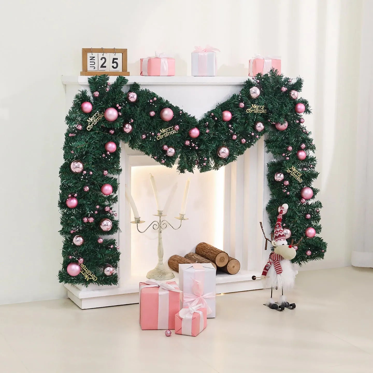 Pink Christmas rattan vine garland draped in a loop, showing small fruit details and LED lights.