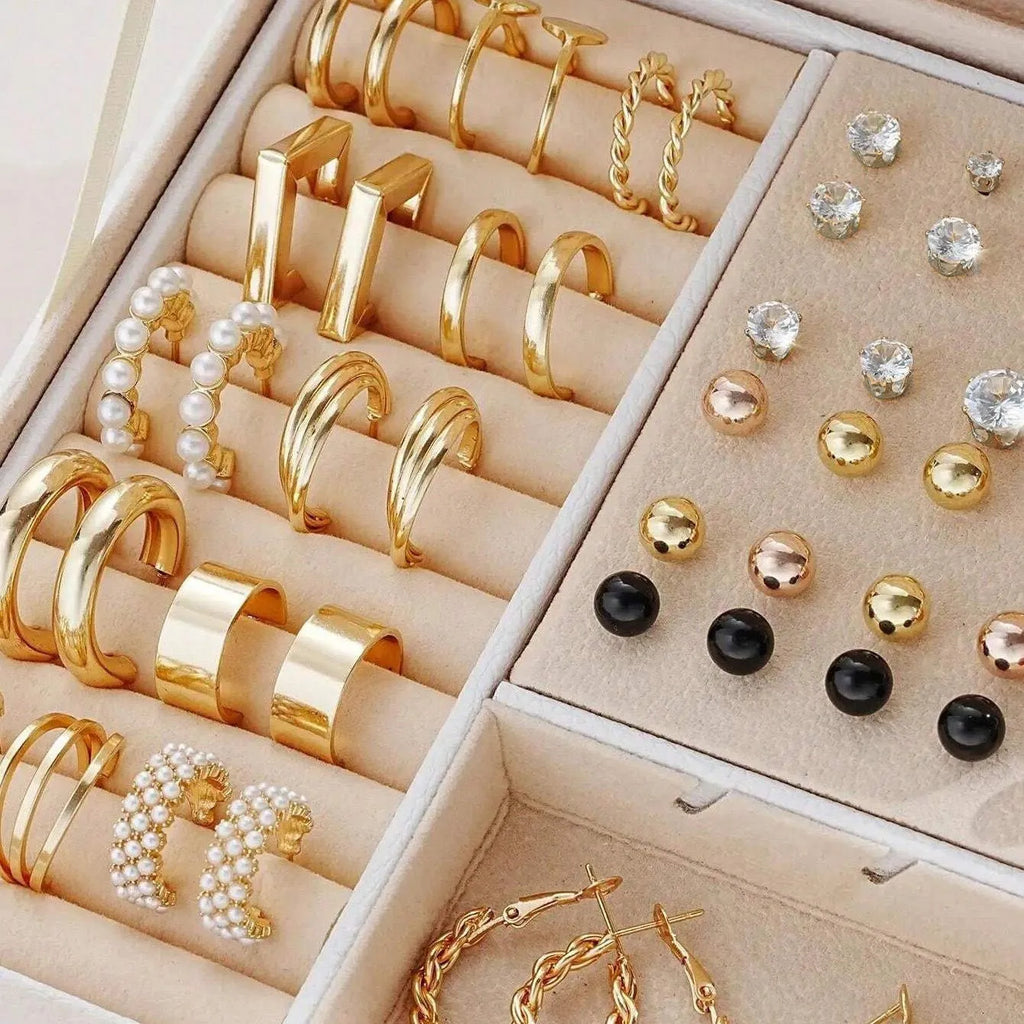 108 gold and yellow geometric round pearl earrings spread out, showing electroplated alloy construction.