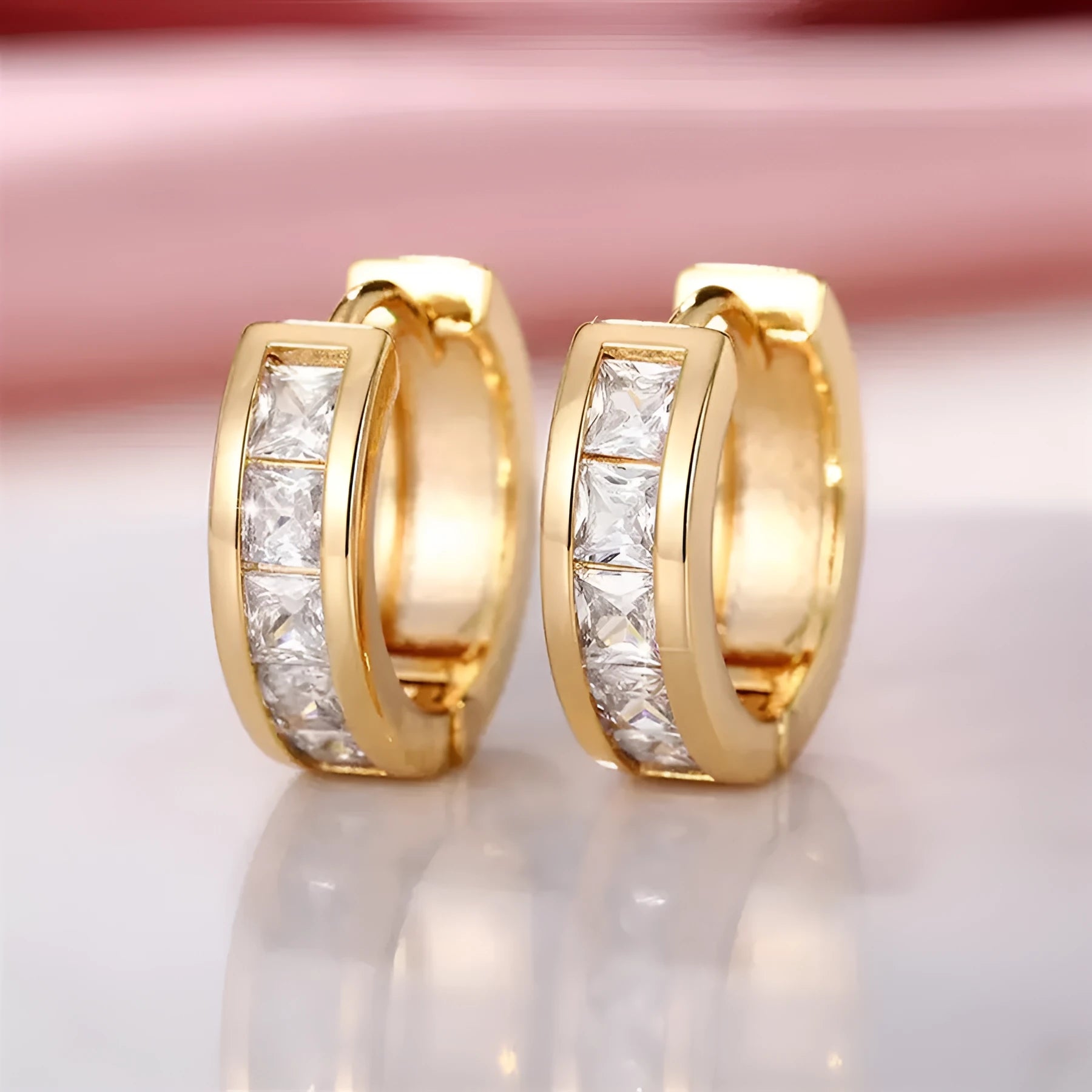 A pair of geometric quadrilateral earrings for women in a gold or silver metal finish.