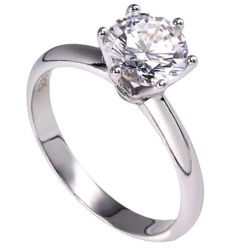 Geometric six-claw zircon ring with a white gold plated finish on a white copper band.
