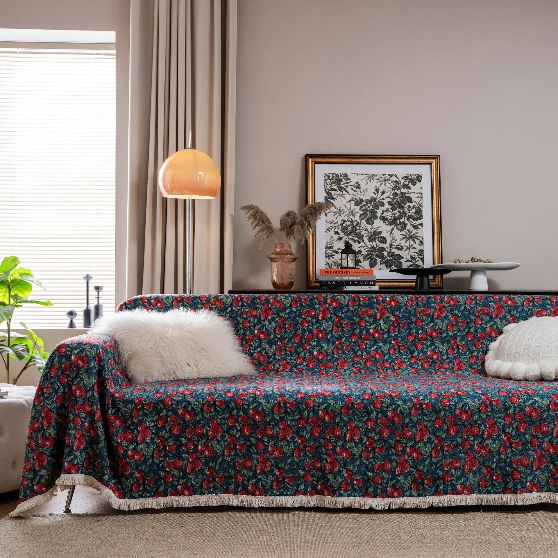 American country style jacquard patterned sofa cover in a green colourway draped over a sofa.