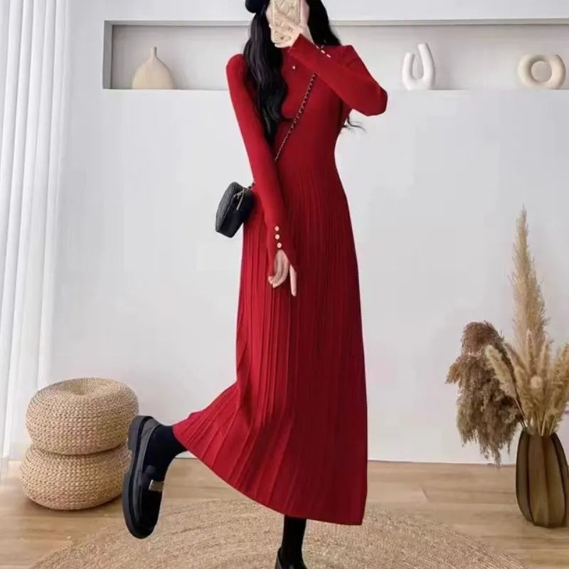 A women's high-waist, mid-length A-line acrylic knit skirt in a solid colour.