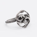 Steel colour titanium steel double snake ring on a finger, showing retro design.