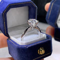 Geometric six-claw zircon ring with a white gold plated finish on a white copper band.
