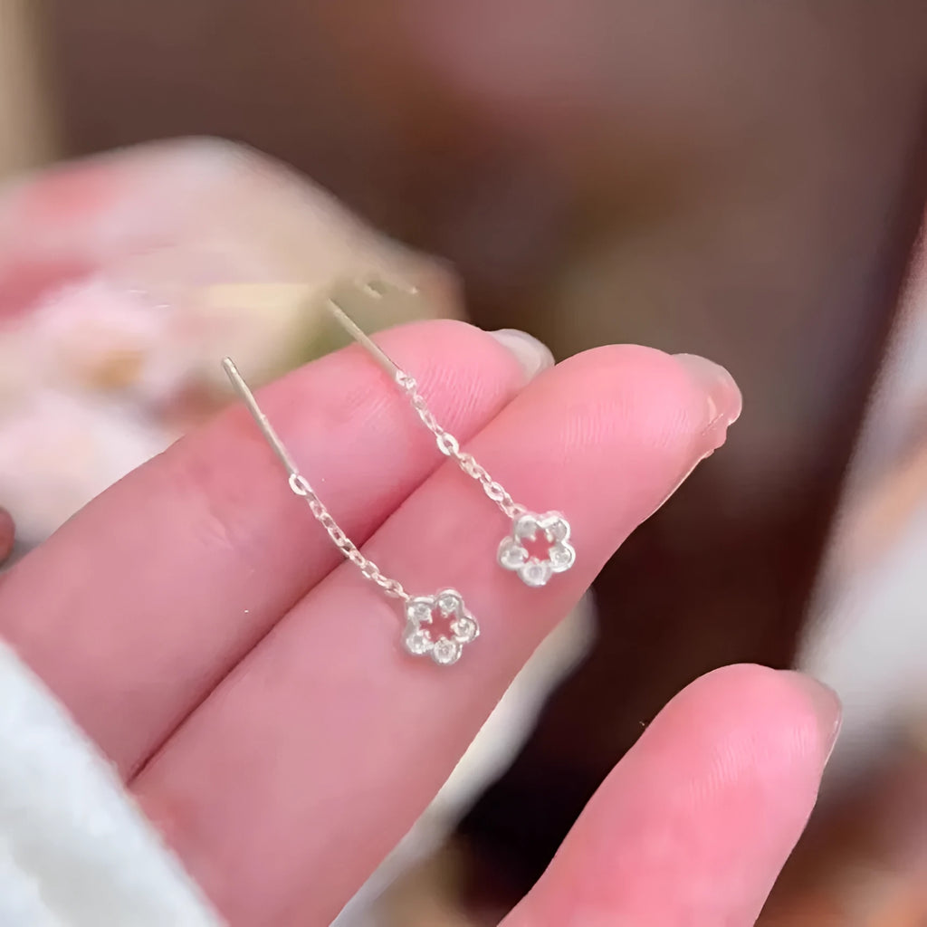 Sterling silver hollow flower drop earrings with petal design and hook fastening