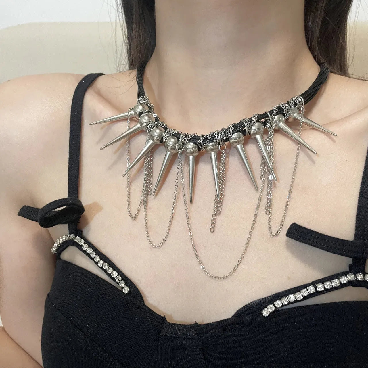 Leather necklace with round beads and winding tassel featuring rivet details in picture colour