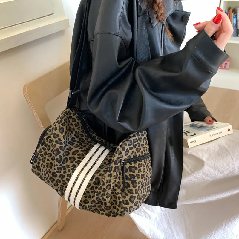 Large capacity leopard print sports style shoulder messenger bag with cloth construction and stitching details