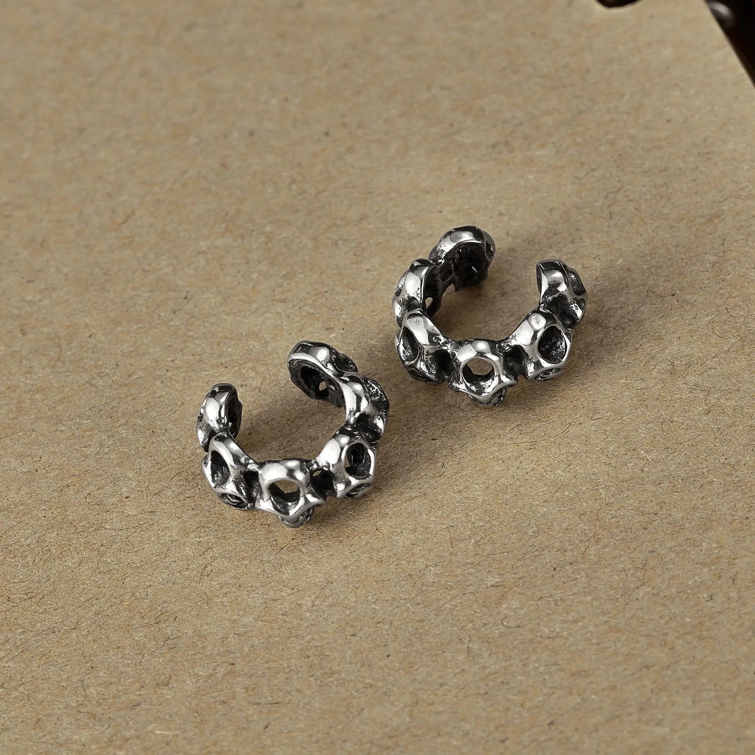 Stainless steel retro skull ear clip earrings with hollow geometric design