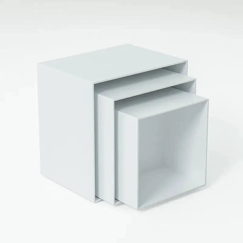 White and clear plastic modular six-piece suit cube dessert display stand on a desktop.