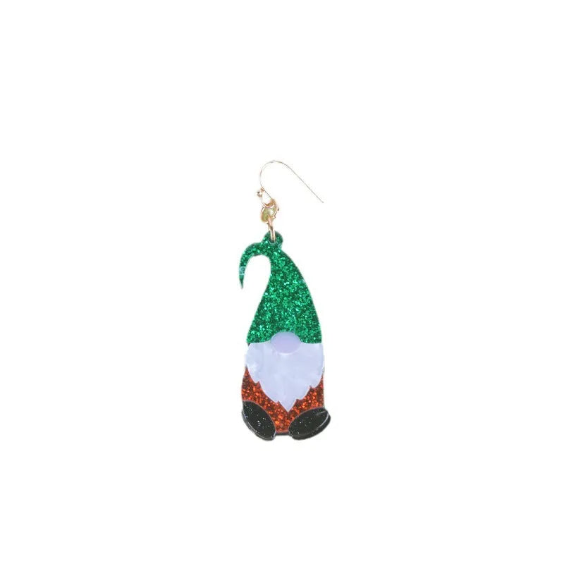 Close-up of a pair of Santa Claus cartoon acrylic earrings in red, green, and red-and-green hat designs on a light background
