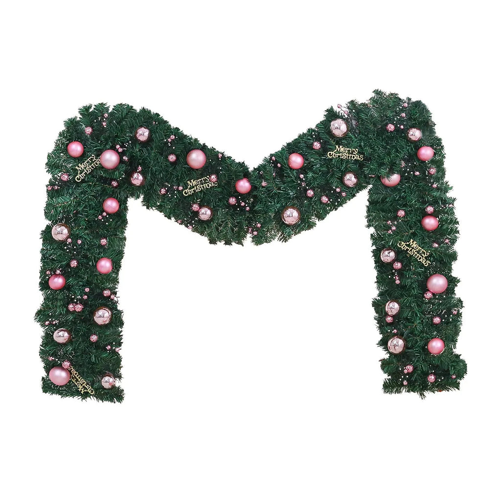 Pink Christmas rattan vine garland draped in a loop, showing small fruit details and LED lights.