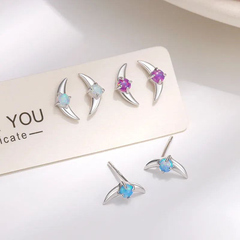 A pair of women's geometric earrings made from 925 silver, shown in gold plating with a blue stone accent.