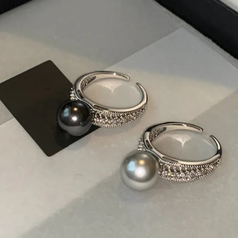 Black pearl geometric open ring with adjustable opening on index finger